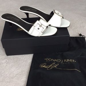 Donald J Pliner white patent leather slides.